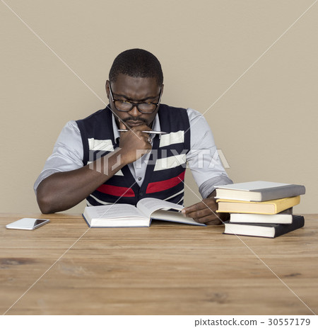 African Man Curious Thinking Reading Book Studio Portrait African Man Curious Thinking Reading Book Studio Portrait 30557179