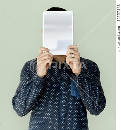 Man holding blank digital tablet cover face studio portrait Man holding blank digital tablet cover face studio portrait 30557368