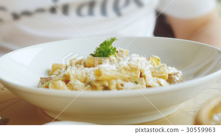 Parmesan over the pasta dish finished before 30559963