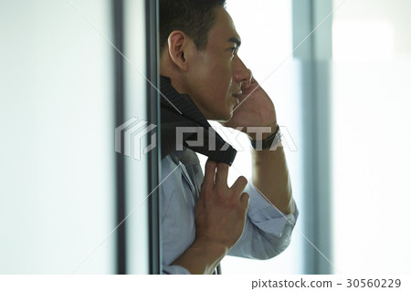 the man is making a phone call. the man is making a phone call. 30560229