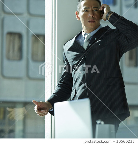 the businessman is having a phone call. the businessman is having a phone call. 30560235