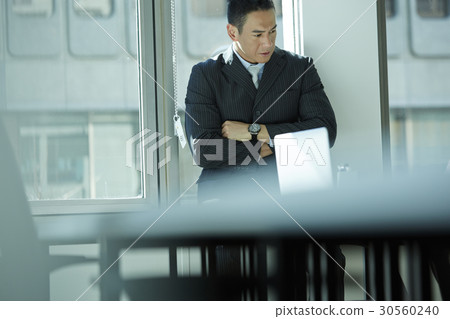 the businessman is folding arms and thinking something. the businessman is folding arms and thinking something. 30560240