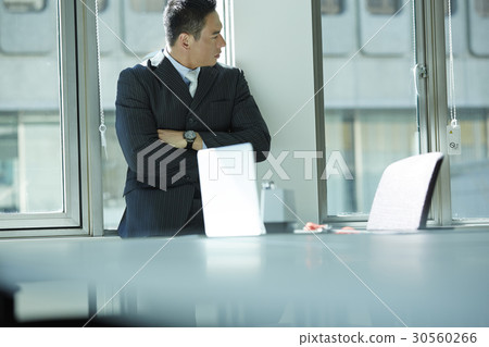 the businessman folding arms is looking at something. the businessman folding arms is looking at something. 30560266