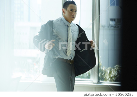 the businessman is wearing the suit. the businessman is wearing the suit. 30560283