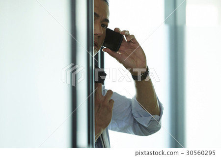 the businessman is talking on phone. 30560295