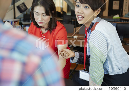 A businesswoman sharing ideas with colleagues A businesswoman sharing ideas with colleagues 30560440