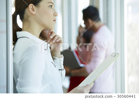 A businesswoman holding documents and thinking 30560441