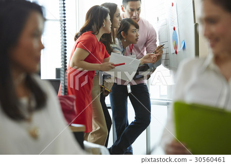 Four of six staff are looking at a chart Four of six staff are looking at a chart 30560461