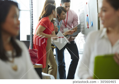 Four of six people are looking at a board Four of six people are looking at a board 30560465
