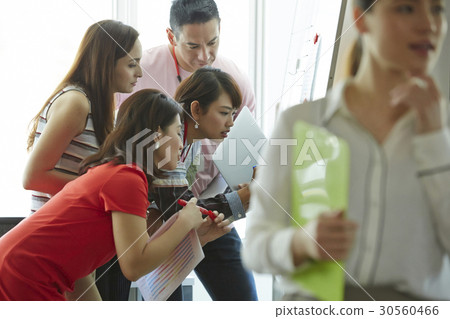 Four of five people are concentrating on something Four of five people are concentrating on something 30560466