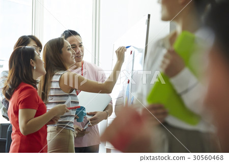 A happy woman is pointing something for her team A happy woman is pointing something for her team 30560468
