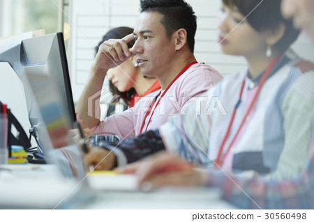 A portrait of a man looking and thinking next to colleagues 30560498