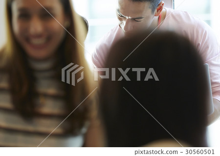 A man is looking down and a woman is smiling 30560501