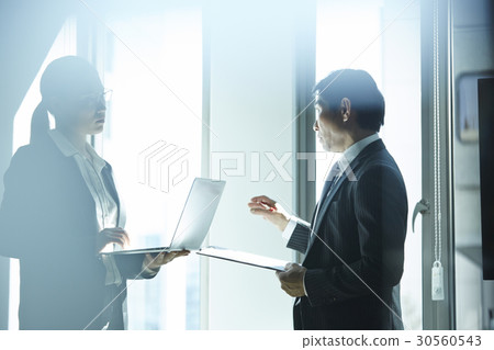 A discussion of two people in office A discussion of two people in office 30560543