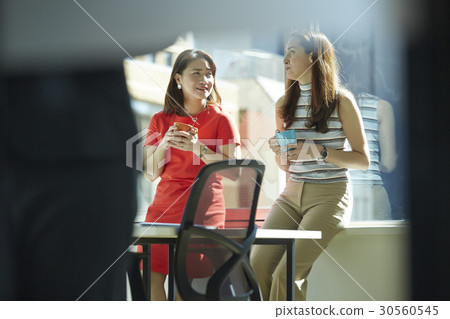 Two businesswomen enjoy teatime together Two businesswomen enjoy teatime together 30560545