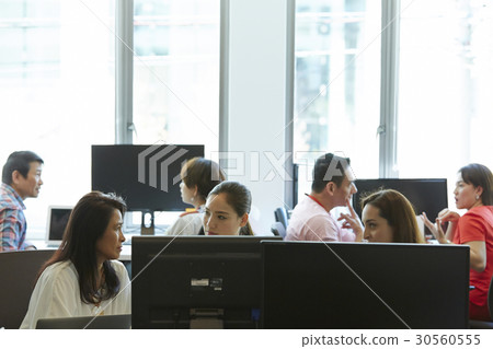 Business people discussing and working together in office. Business people discussing and working together in office. 30560555