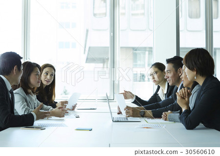 The colleagues are discussing at a meeting in office. The colleagues are discussing at a meeting in office. 30560610