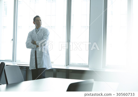 a portrait of a man standing and looking at something 30560733