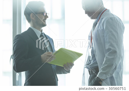 a portrait of two people discussing 30560751