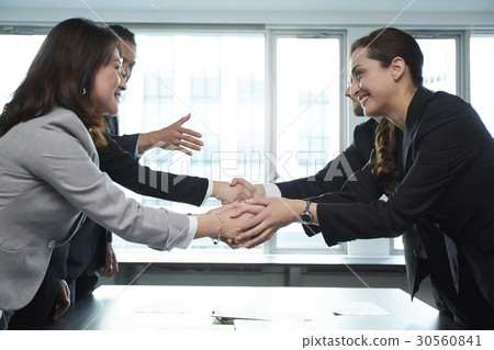 a portrait of people happily shaking hands a portrait of people happily shaking hands 30560841