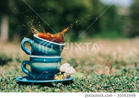 Two blue ceramic cups with a splash Two blue ceramic cups with a splash 30561699