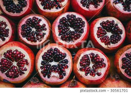 Rows sliced pomegranate on the market Rows sliced pomegranate on the market 30561701