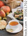 White cup with tea and cookies on a wooden table 30561702