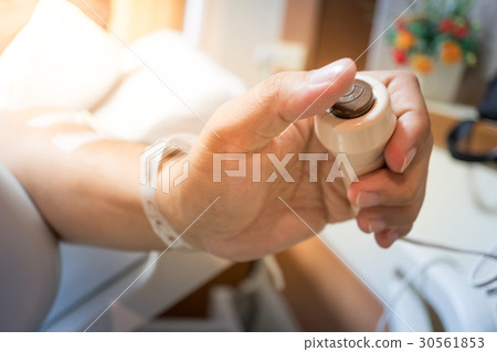 Patient hand pressing emergency nurse call button 30561853