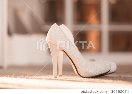 High heels white wedding shoes on a floor 30562074