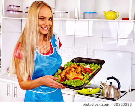 Women in kitchen is cooking roast meat food in Women in kitchen is cooking roast meat food in 30563832