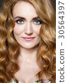 Beautiful young woman with long red curvy hair 30564397