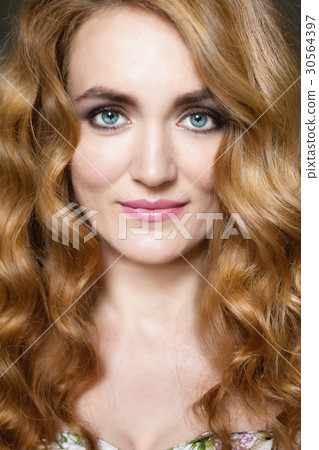 Beautiful young woman with long red curvy hair Beautiful young woman with long red curvy hair 30564397