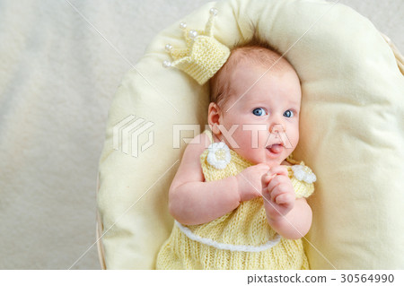 Newborn baby girl lying in a basket with crown and Newborn baby girl lying in a basket with crown and 30564990