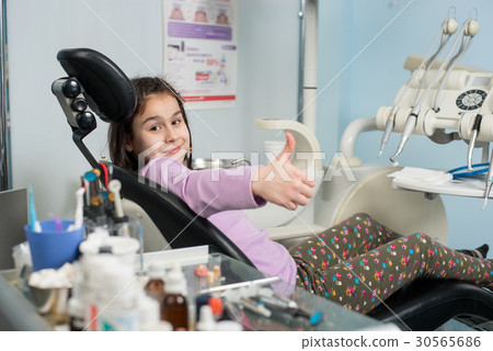 Patient girl at dental clinic office. Medicine 30565686
