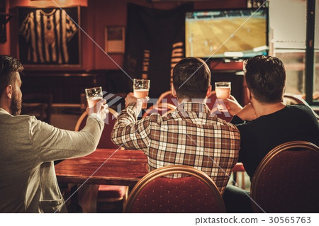 Cheerful old friends watching sports and drinking 30565763