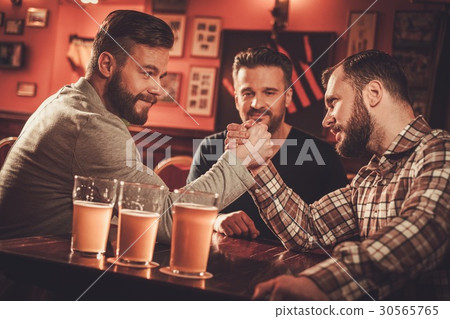 Cheerful old friends having arm wrestling 30565765