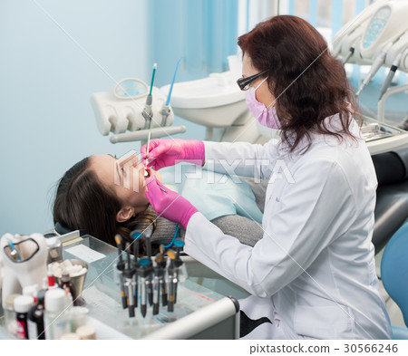 Female dentist with patient in the dental office Female dentist with patient in the dental office 30566246
