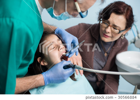 Pediatric dentist doing first check-up for patient Pediatric dentist doing first check-up for patient 30566884