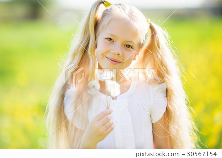Little blonde girl with dandelion 30567154