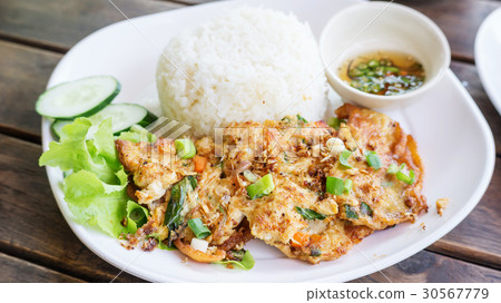 omelet (Thai style) with rice on a white plate. 30567779