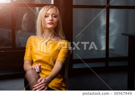 Studio shot of young and beautiful girl in yellow Studio shot of young and beautiful girl in yellow 30567949