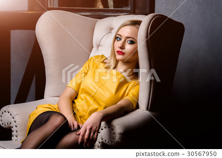 Studio shot of young and beautiful girl in yellow Studio shot of young and beautiful girl in yellow 30567950