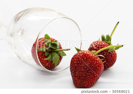 Strawberry berries in a glass of wine. Strawberry berries in a glass of wine. 30568021
