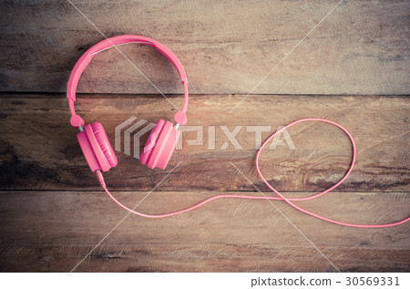 Pink headphones on the wooden floor Pink headphones on the wooden floor 30569331