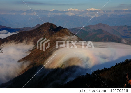 Brocken phenomenon reflected in clouds crossing the ridgeline seen from Onigatake and Southern Alps distant view Brocken phenomenon reflected in clouds crossing the ridgeline seen from Onigatake and Southern Alps distant view 30570366