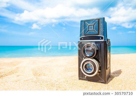 Vintage twin lens reflex camera on the sand beach Vintage twin lens reflex camera on the sand beach 30570710
