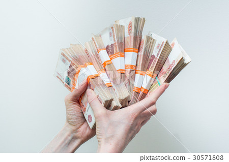 hand holding many of the Russian banknotes hand holding many of the Russian banknotes 30571808