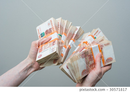 hand holding many of the Russian banknotes hand holding many of the Russian banknotes 30571817
