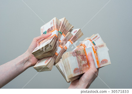 hand holding many of the Russian banknotes hand holding many of the Russian banknotes 30571833
