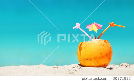 Coconut with straws and colorful cocktail umbrella 30571953